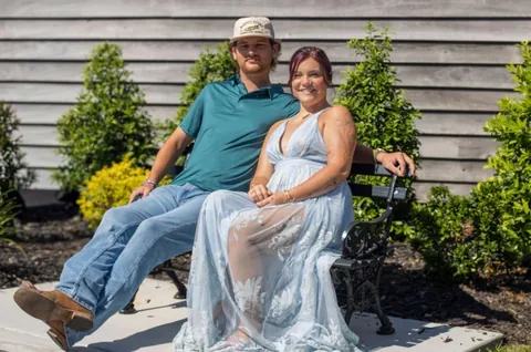 Couple seated together on a garden bench