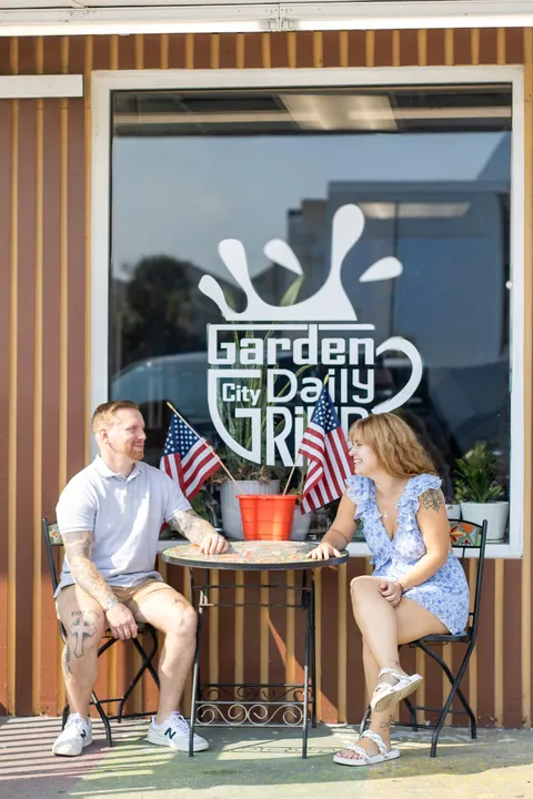 Couple sharing coffee outside a Garden City coffee shop
