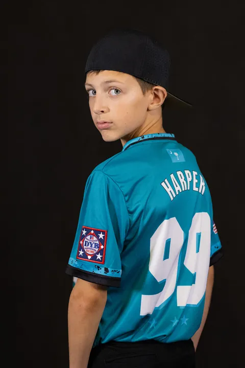 Young baseball player looking back over his shoulder